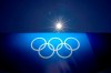 The sun shines above an image of the Olympic rings at Yokohama Baseball Stadium as the venue is prepared for softball competition at the 2020 Summer Olympics, Thursday, July 22, 2021, in Yokohama, Japan. (AP Photo/Matt Slocum)