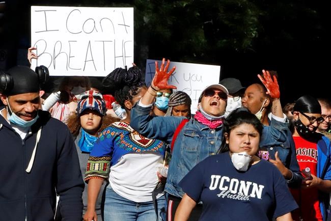 A group marches through the streets of downtown Pittsburgh Sunday, May 31, 2020 protesting the death of George Floyd, who died after being restrained by Minneapolis police officers on Memorial Day, May 25. (AP Photo/Gene J. Puskar)