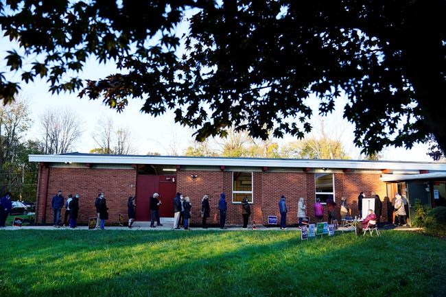 People line up outside a polling place to vote in the 2020 general election in the United States, Tuesday, Nov. 3, 2020, in Springfield, Pa. (AP Photo/Matt Slocum)