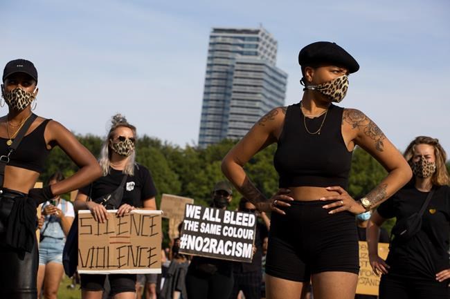 People observe social distancing as they take part in a demonstration in The Hague, Netherlands, Tuesday, June 2, 2020, to protest against the recent killing of George Floyd, police violence and institutionalized racism. Floyd, a black man, died in police custody in Minneapolis, U.S.A., after being restrained by police officers on Memorial Day. (AP Photo/Peter Dejong)