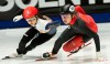 Hwang Dae Heon, left, of South Korea, and Canada’s Courtney Lee Sarault skate through a turn during the final of the 1000 meter short track speed skating championships in Montreal, Sunday, Jan. 12, 2020. THE CANADIAN PRESS/Peter McCabe