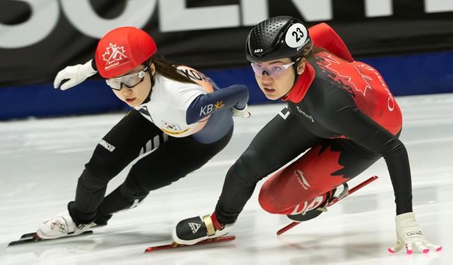 Hwang Dae Heon, left, of South Korea, and Canada’s Courtney Lee Sarault skate through a turn during the final of the 1000 meter short track speed skating championships in Montreal, Sunday, Jan. 12, 2020. THE CANADIAN PRESS/Peter McCabe