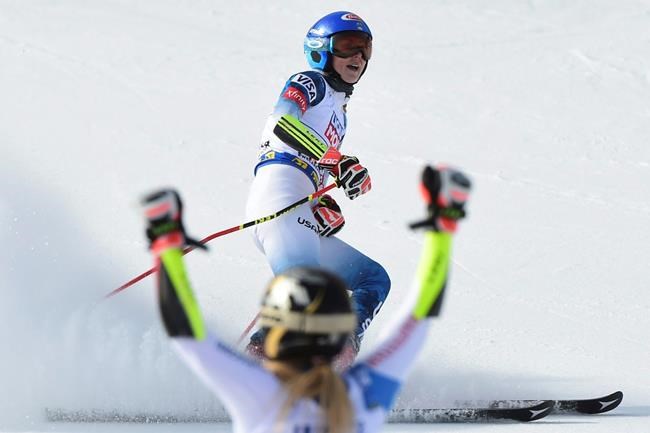Switzerland's Lara Gut-Behrami celebrates winning the gold medal as United States' Mikaela Shiffrin comes in second in a women's giant slalom, at the alpine ski World Championships, in Cortina d'Ampezzo, Italy, Thursday, Feb. 18, 2021. (AP Photo/Marco Tacca)