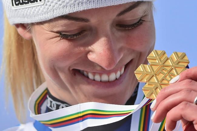 Switzerland's Lara Gut-Behrami eyes her gold medal after a women's giant slalom, at the alpine ski World Championships, in Cortina d'Ampezzo, Italy, Thursday, Feb. 18, 2021. (AP Photo/Marco Tacca)