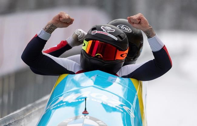 Kaillie Humphries and Sylvia Hoffmann from the US celebrate after winning the women's bob World Cup in Koenigsee, Germany, Saturday, Jan.25, 2020. (Sven Hoppe/dpa via AP)