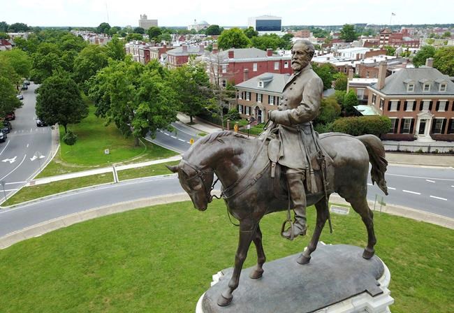 FILE - This Tuesday, June 27, 2017 file photo shows the statue of Confederate General Robert E. Lee that stands in the middle of a traffic circle on Monument Avenue in Richmond, Va. Virginia Gov. Ralph Northam is expected to announce plans Thursday for the removal of an iconic statue of Confederate Gen. Robert E. Lee from Richmond's prominent Monument Avenue. (AP Photo/Steve Helber, File)