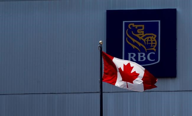 A Canadian flag flies near a branch of the Royal Bank in Ottawa, Monday, July 6, 2020. Royal Bank of Canada says it is dropping its partnership with WE Charity and will no longer sponsor or donate to the organization. THE CANADIAN PRESS/Adrian Wyld