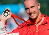 Canada's Thomas Hall of Pointe-Claire, Que. celebrates his bronze medal win in the canoe single (C1) 1000 meter final at the Beijing Olympics in Beijing, China, Friday, Aug. 22, 2008. Former Olympic canoeist Hall can only imagine the emotional and financial turmoil Canada's athletes are experiencing in the wake of the news they will not compete in the Tokyo Games if those games do go ahead this summer.  THE CANADIAN PRESS/Jonathan Hayward