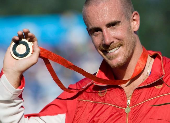 Canada's Thomas Hall of Pointe-Claire, Que. celebrates his bronze medal win in the canoe single (C1) 1000 meter final at the Beijing Olympics in Beijing, China, Friday, Aug. 22, 2008. Former Olympic canoeist Hall can only imagine the emotional and financial turmoil Canada's athletes are experiencing in the wake of the news they will not compete in the Tokyo Games if those games do go ahead this summer. THE CANADIAN PRESS/Jonathan Hayward