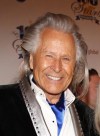 Peter Nygard arrives at the 24th Night of 100 Stars Oscars Viewing Gala at The Beverly Hills Hotel in Beverly Hills, Calif., on March 2, 2014. Dozens more women, including Canadians, have added their names to a class action lawsuit alleging rape and sexual assault by fashion mogul Nygard. THE CANADIAN PRESS/AP, Invision - Annie I. Bang