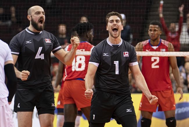 TJ Sanders (right) celebrates along with Nicholas Hoag after blocking a spike attempt by Cuba during the men's volleyball 2020 Olympic qualification tournament at the Pacific Coliseum in Vancouver, on Saturday, January 11, 2020. The postponement of the Tokyo Games to 2021 is a boon to several Canadian athletes whose injuries would have kept them out of the Games this summer, or whose performance and preparation would have been compromised by injury. They have the luxury of time now. THE CANADIAN PRESS/Richard Lam