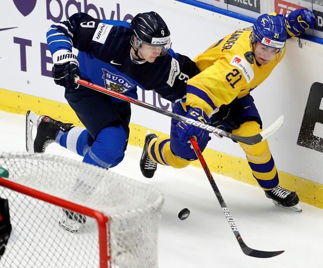 Finland's Toni Utunen, left, challenges Sweden's Nils Hoglander, right, during the U20 Ice Hockey Worlds bronze medal match between Finland and Sweden in Ostrava, Czech Republic, Sunday, Jan. 5, 2020.The Vancouver Canucks have signed left-winger Hoglander to a three-year entry-level contract. THE CANADIAN PRESS/AP/Petr David Josek