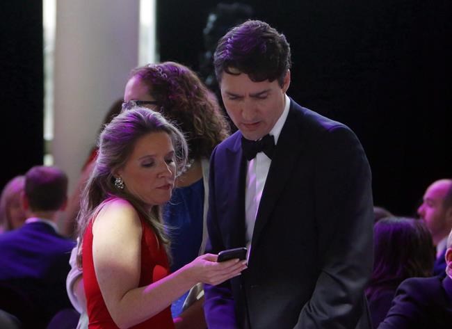 Prime Minister Justin Trudeau confers with his chief of staff Katie Telford at the National Press Gallery Dinner in Gatineau, Quebec, Saturday June 3, 2017. Trudeau is to testify Thursday afternoon about his government's decision to get the WE organization to run a summer student-volunteer program.His chief of staff Telford is to follow him for questioning by the House of Commons finance committee. THE CANADIAN PRESS/Fred Chartrand