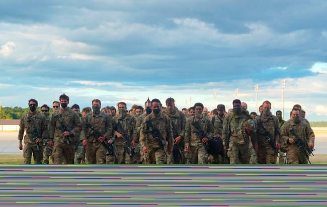 In this photo provided by the U.S. Army, members of Fort Bragg's 82nd Airborne Division's Immediate Response Force return Friday, May 1, 2020, at Pope Army Airfield, in North Carolina. The paratroopers suddenly deployed in January amid rising tensions with Iran. (U.S. Army via AP)