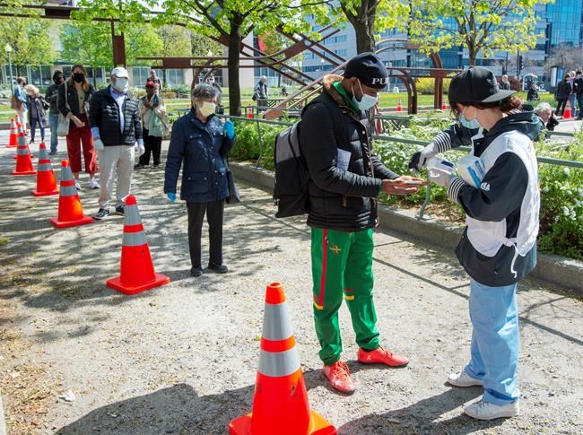 People line up at a mobile COVID-19 testing clinic, Tuesday May 19, 2020 in Montreal.THE CANADIAN PRESS/Ryan Remiorz