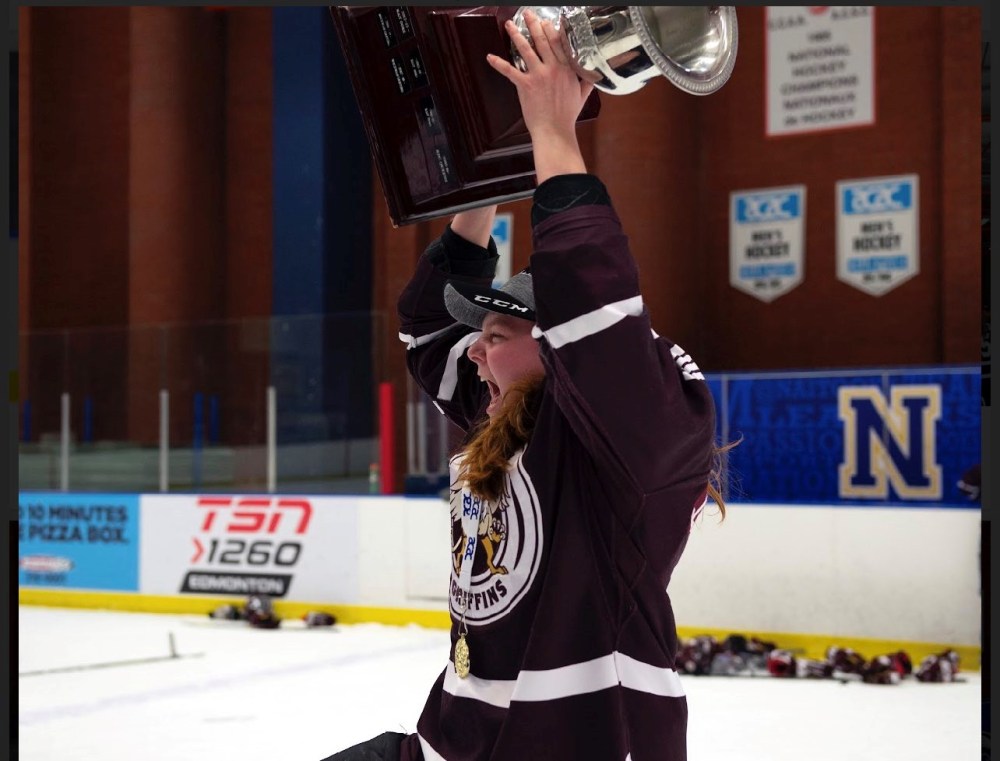 Jenna Thompson photoReimer celebrating with the trophy at the 2019 ACAC Women's Hockey Championship.