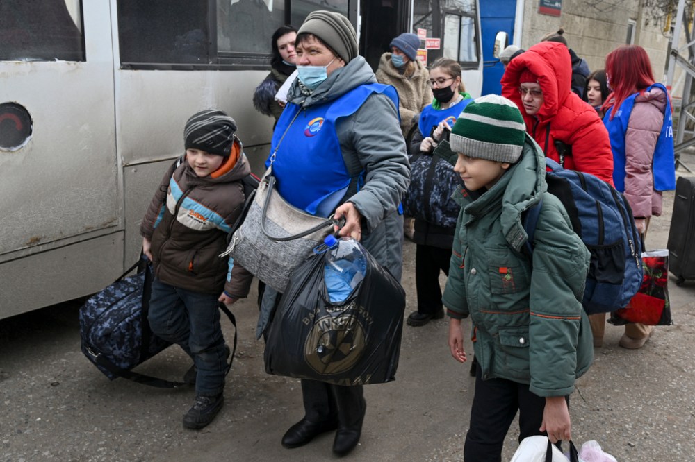 People evacuated from the Donetsk and Luhansk regions, the territory controlled by a pro-Russia separatist in eastern Ukraine, leave a bus to be taken to temporary residences in other regions of Russia, in Taganrog, Russia, Tuesday, Feb. 22, 2022. From a hastily convened meeting of the United Nations Security Council to capitals around the world, leaders have condemned Russian President Vladimir Putin's recognition of two pro-Russia regions in eastern Ukraine as independent and his order to send troops there. (AP Photo)