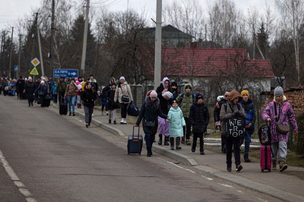 CP
Ukrainian refugees walk along the road between Lviv and Shehyni, in Volytsya, Ukraine on Saturday. Is it estimated more than two million people have been forced to flee the country so far. (Marc Sanye / The Associated Press files)