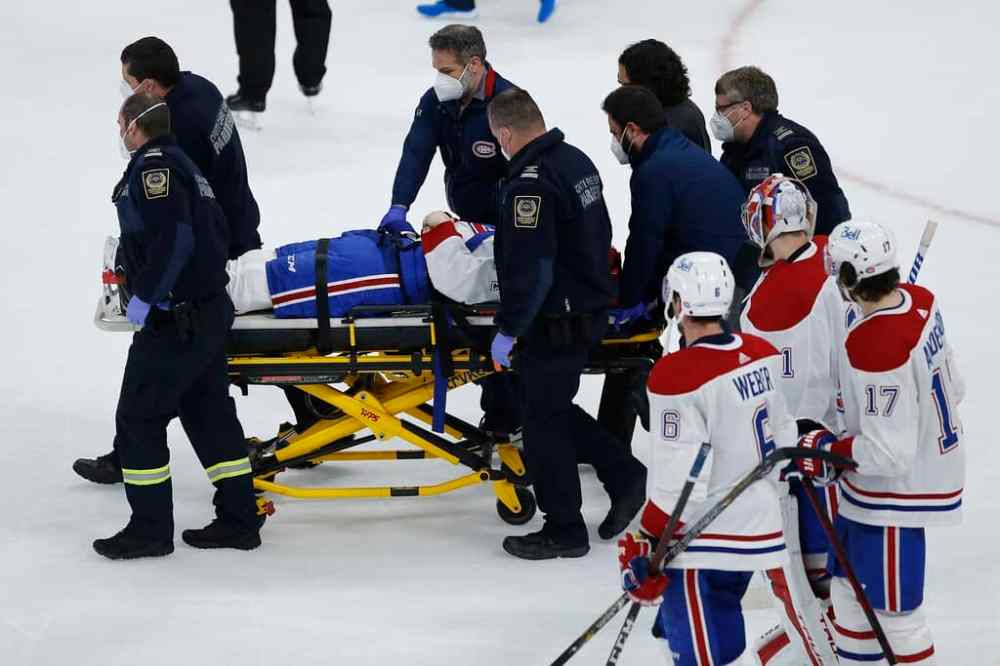 CP
Montreal Canadiens' players watch as teammate Jake Evans is taken off the ice on a stretcher after getting hit by Winnipeg Jets' Mark Scheifele Wednesday. THE CANADIAN PRESS/John Woods