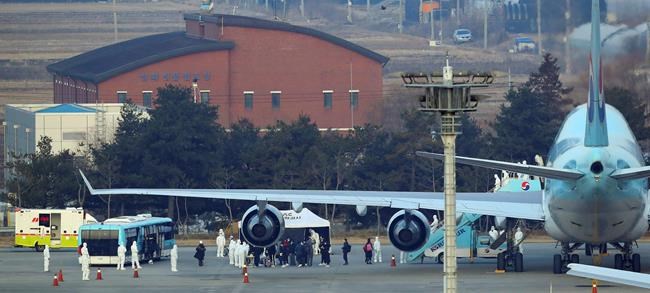 South Koreans that were evacuated from Wuhan, China, disembark from a chartered flight at Gimpo Airport in Seoul, South Korea, Friday, Jan. 31, 2020. South Korea sent planes to fly back home more of their nationals from the Chinese city of Wuhan, the epicenter of a new virus. (Kim Kyun-hyun/Newsis via AP)