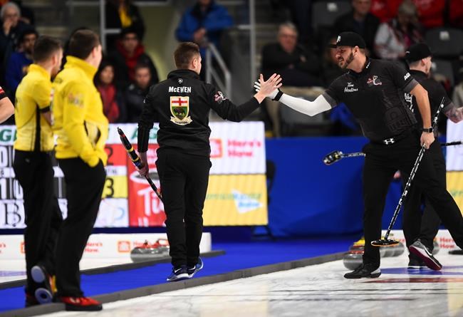Team Wild Card skip Mike McEwen, middle, reacts with teammate second Derek Samagalski as they play Team Manitoba in the championship pool at the Brier in Kingston, Ont., on Thursday, March 5, 2020. THE CANADIAN PRESS/Sean Kilpatrick