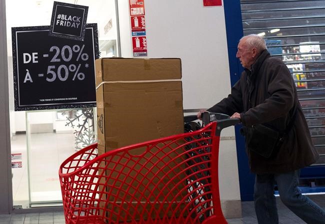 A shopper is seen during the opening of an Auchan general store, on Black Friday, Nov 29, 2019, in Englos, northern France. Some French lawmakers want to ban Black Friday, the post-Thanksgiving sales event that has morphed into a global phenomenon. (AP Photo/Michel Spingler)