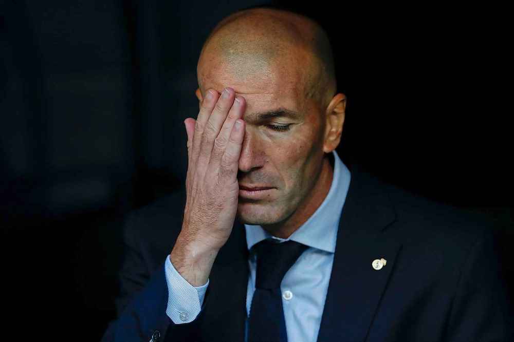 Try to stop touching your face, unless you are Real Madrid's head coach Zinedine Zidane and can't help yourself. (Manu Fernandez / The Associated Press files)