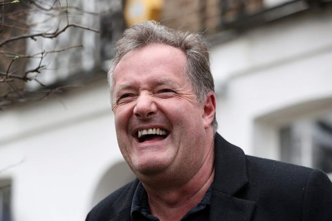 British television host Piers Morgan laughs as he speaks to reporters outside his home in Kensington, central London, Wednesday March 10, 2021. Morgan quit the “Good Morning Britain” program on Tuesday after making controversial comments about the Duchess of Sussex. The U.K.’s media watchdog said earlier Tuesday it was launching an investigation into the show under its harm and offense rules after receiving more than 41,000 complaints about Morgan’s comments on Meghan. (Jonathan Brady/PA via AP)