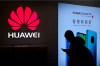 In this Dec. 11, 2018, photo, a man browses his smartphone outside a Huawei store at a shopping mall in Beijing. Chinese telecom giant Huawei Technologies says its sales rose about 18 percent in 2019 despite U.S. pressure to restrict its business. The estimate came Tuesday, Dec. 31, 2019 in an annual New Year's message to employees. The letter predicts a difficult year in 2020, saying that the U.S. (AP Photo/Andy Wong)