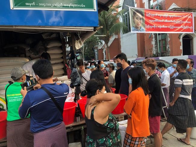 People stock up rice in Yangon, Myanmar Monday, Feb. 1, 2021. Myanmar military television said Monday that the military was taking control of the country for one year, while reports said many of the country’s senior politicians including Aung San Suu Kyi had been detained. (Andrew Nachemson via AP)