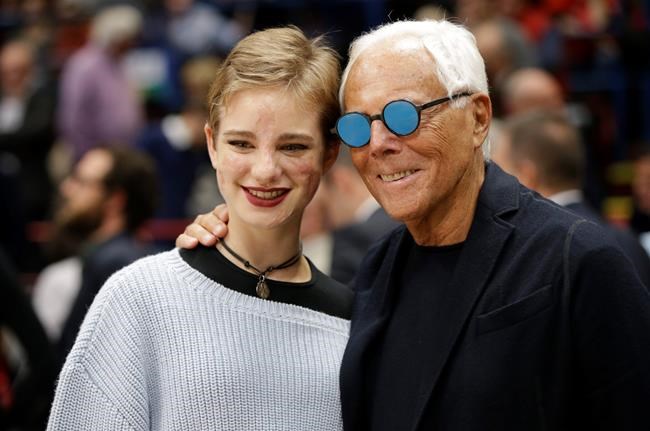 FILE - In this Oct. 27, 2016, file photo, Giorgio Armani and paralympic champion Beatrice 'Bebe' Vio pose during a Euroleague basketball match between EA7 Emporio Armani Milan and Real Madrid in Assago, near Milan, Italy. Vio is among several Paralympic athletes who are profiled in the Nexflix documentary “Rising Phoenix” that will be released in 190 countries on Wednesday, Aug. 26, 2020.(AP Photo/Luca Bruno, File)
