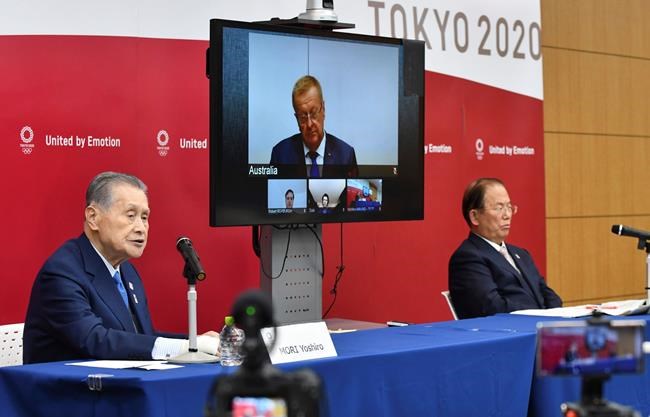 Tokyo 2020 Organizing Committee President Yoshiro Mori, left, and CEO Toshiro Muto, right, attend teleconference with International Olympic Committee member John Coates, who heads the inspection team for Tokyo Olympics, in Tokyo Thursday, April 16, 2020. Tokyo Olympic organizers and the IOC said Thursday they will cut some of the extras out of next year’s postponed games, an attempt to limit what is expected to be billions of dollars in added expenses.(Kazuhiro Nogi/Pool Photo via AP)