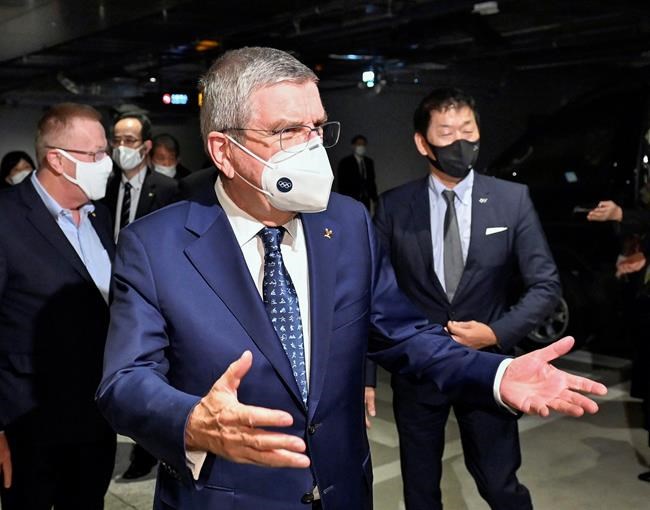 International Olympic Committee President Thomas Bach gestures on his arrival at a hotel in Tokyo Sunday, Nov. 15, 2020. IOC President Bach is beginning a visit to Tokyo to convince politicians and the Japanese public that the postponed Olympics will open in just over eight months.(Kyodo News via AP)