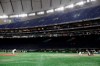 FILE - In this Saturday, Feb. 29, 2020, file photo, spectators' stands are empty during play in a preseason baseball game between the Yomiuri Giants and the Yakult Swallows at Tokyo Dome in Tokyo. IOC officials announced on Monday, March 2, 2020, that a baseball qualifying event for Tokyo Olympics was postponed from April to June. (AP Photo/Eugene Hoshiko, File)
