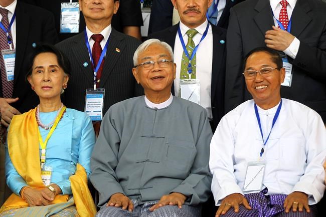 FILE - In this May 24, 2017, file photo, Myanmar's Vice President Myint Swe, right, smiles while sitting with State Counsellor Aung San Suu Kyi, left, and then President Htin Kyaw during a photo session after the second session of the 21st Century Panglong Union Peace Conference at the Myanmar International Convention Center in Naypyitaw, Myanmar. Myanmar military television said Monday, Feb. 1, 2021 that the military was taking control of the country for one year, while reports said many of the country’s senior politicians including Suu Kyi had been detained. The military TV report said Commander-in-Chief Senior Gen. Min Aung Hlaing would be in charge of the country, while Myint Swe would be elevated to acting president. (AP Photo/Aung Shine Oo, File)