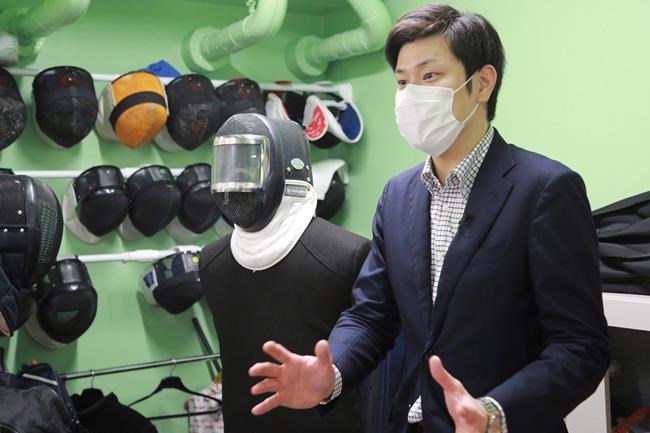 Fencing instructor Hiroshi Kato speaks during an interview with The Associated Press in Tokyo on June 21, 2021. Kato said he worries that he’ll lose even more business than he did during the coronavirus pandemic because he’s been ordered to move from the building where he works across from the main Olympics stadium from July 1 to Sep. 19, for unspecified security reasons. (AP Photo/Koji Sasahara)