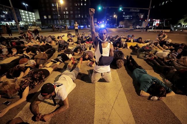 Protesters lay in the middle of the intersection of Dr. Martin Luther King, Jr. Blvd. and Second Avenue in Memphis Thursday, June 4, 2020 for the protests over the death of George Floyd. Floyd died after being restrained by Minneapolis police officers on May 25. (Patrick Lantrip/Daily Memphian via AP)