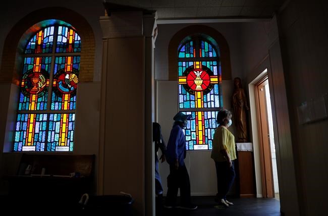 Parishioners wear face masks as they file out of an in-person Mass at Christ the King Catholic Church in San Antonio, Tuesday, May 19, 2020. San Antonio parishes that have been closed due to the COVID-19 pandemic have began opening their doors to in-person services. (AP Photo/Eric Gay)