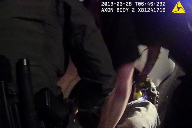 In this image made from a March 28, 2019, body-worn camera video provided by the Austin Police Department in Texas, Williamson County deputies hold down Javier Ambler as one of them uses a Taser on Ambler’s back during his arrest in Austin, Texas. The black man died in custody in 2019 after sheriff's deputies repeatedly used stun guns on him, despite his pleas that he was sick and couldn't breathe, according a report published Monday, June 8, 2020, by the Austin American-Statesman and KVUE-TV. The video was made on the camera worn by an Austin police officer who also showed up at the scene as Williamson County deputies were making the arrest. (Austin Police Department via AP)