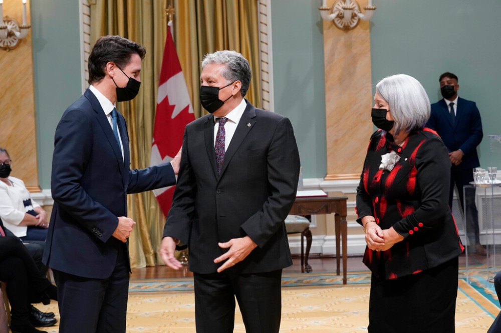 Dan Vandal (centre) is greeted by by Prime Minister Justin Trudeau (left) and Gov. Gen. Mary May Simon (right) at the swearing-in ceremony Tuesday in Ottawa. (Adrian Wyld / The Canadian Press)