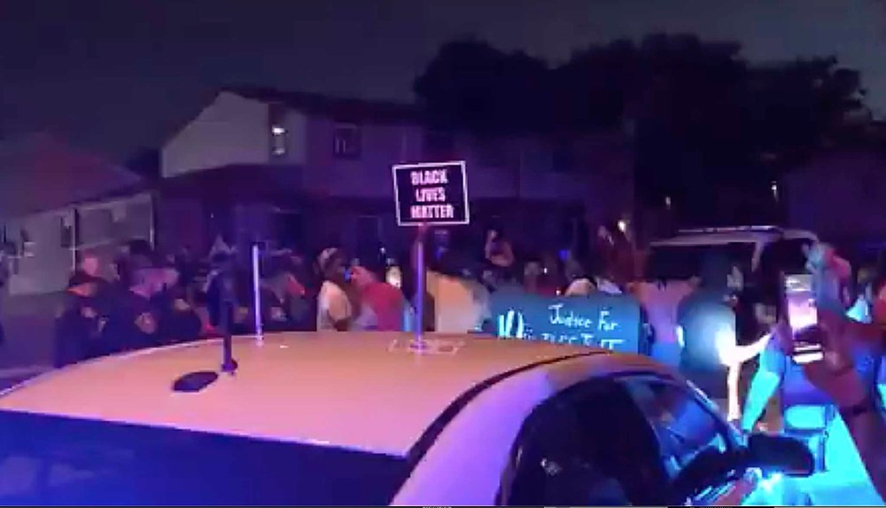 CP
In this image made from video, protesters gather near the site of a police shooting, Sunday, Aug. 23 in Kenosha, Wisconsin. Officers deployed tear gas early Monday in an effort to disperse hundreds of people who took to the streets following a police shooting in Kenosha that also drew a harsh rebuke from the governor after a video posted on social media appeared to show officers shoot at a Black man’s back seven times as he leaned into a vehicle. (WDJT-TV via AP)