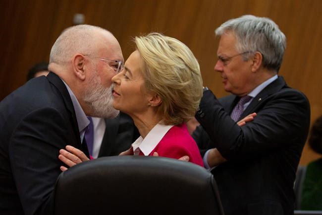 European Commissioner for European Green Deal Frans Timmermans, left, greets European Commission President Ursula von der Leyen prior to an extraordinary meeting of the EU college of commissioners at EU headquarters in Brussels, Wednesday, Jan. 8, 2020. European Union foreign policy chief Josep Borrell is expected to brief the college on Wednesday regarding the current situation in Libya and Iran. (AP Photo/Virginia Mayo)