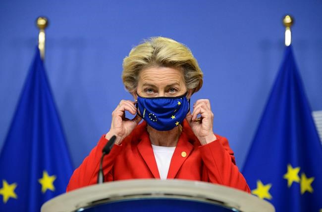 European Commission President Ursula von der Leyen, takes off her protective mask prior to making a statement regarding the Withdrawal Agreement at EU headquarters in Brussels, Thursday, Oct. 1, 2020. The European Union took legal action against Britain on Thursday over its plans to pass legislation that would breach parts of the legally binding divorce agreement the two sides reached late last year. (Johanna Geron, Pool via AP)