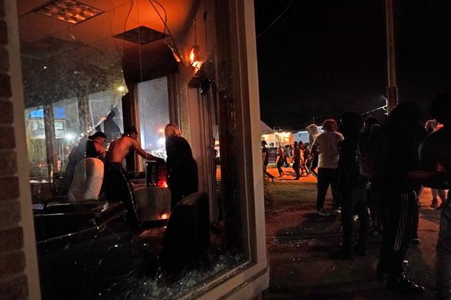 Protesters set fire to an office late Monday, Aug. 24, 2020, in Kenosha, Wis. Protesters converged on the county courthouse during a second night of clashes after the police shooting of Jacob Blake a day earlier turned Kenosha into the nation's latest flashpoint city in a summer of racial unrest. (AP Photo/David Goldman)
