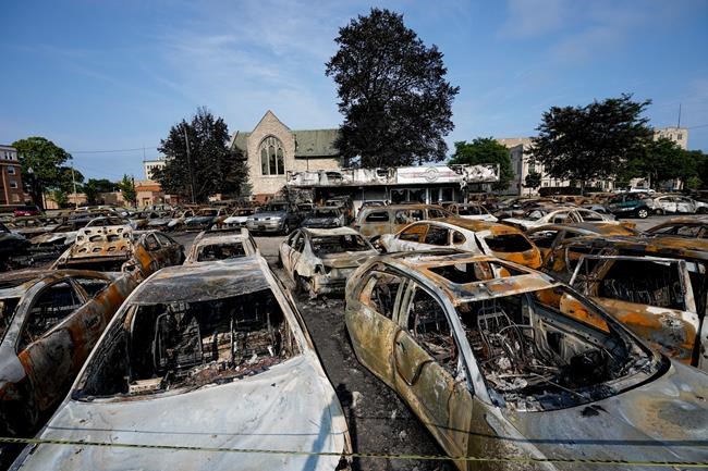 Charred vehicles sit in a lot following a night of unrest, Tuesday, Aug. 25, 2020, in Kenosha, Wis. Anger over the shooting of Jacob Blake, a Black man, by police spilled into the streets of Kenosha for a second night Monday. (AP Photo/Morry Gash)