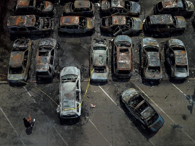 Burned out vehicles are seen Monday, Aug. 24, 2020, in Kenosha, Wis. Many of the cars were set on fire during protests Sunday night after a police shooting in the city. (AP Photo/Morry Gash)