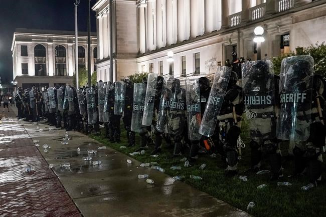 Police clash with protesters near the Kenosha County Courthouse, Monday, Aug. 24, 2020, in Kenosha, Wis. (AP Photo/Morry Gash)