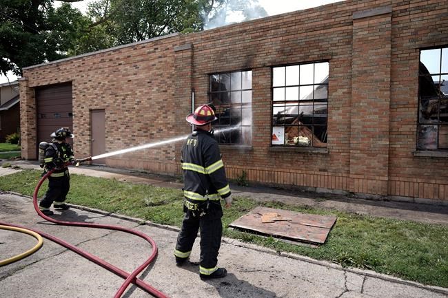 On Tuesday, Aug. 25, 2020, firefighters put out flames at a business that was burned during protests overnight, in Kenosha, Wis. The unrest was in reaction to the shooting of Jacob Blake by a Kenosha Police. (AP Photo/Morry Gash)