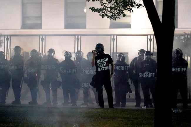 People gather Tuesday, Aug. 25, 2020 to protest in Kenosha, Wis. Anger over the Sunday shooting of Jacob Blake, a Black man, by police spilled into the streets for a third night. (AP Photo/Morry Gash)
