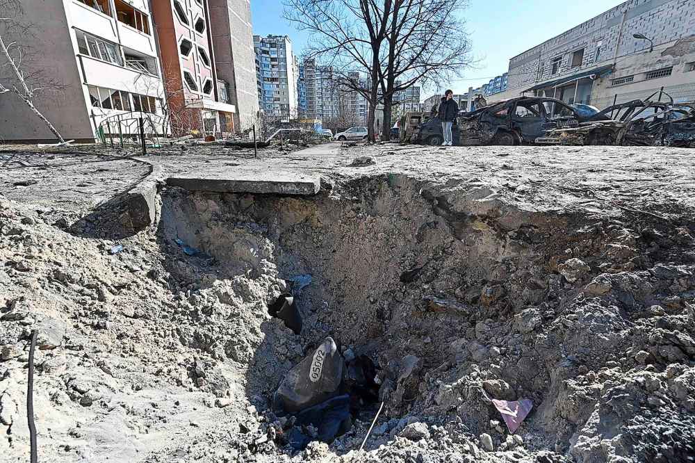Picture shows a crater caused by recent shelling in Kyiv outskirts on Feb. 28, 2022. - The UN human rights chief said on Feb. 28, 2022, that at least 102 civilians, including seven children, had been killed in Ukraine since Russia launched its invasion five days ago, warning the true numbers were likely far higher. (Genya Savilov/AFP via Getty Images/TNS)